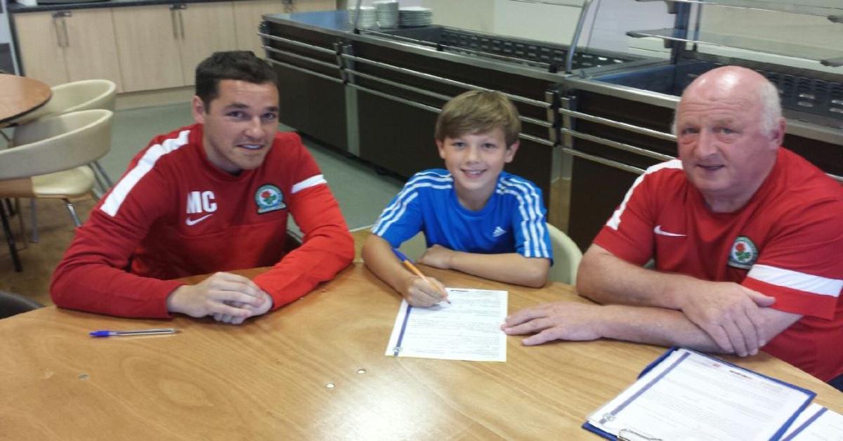 Harry signing for Blackburn at nine-years-old.